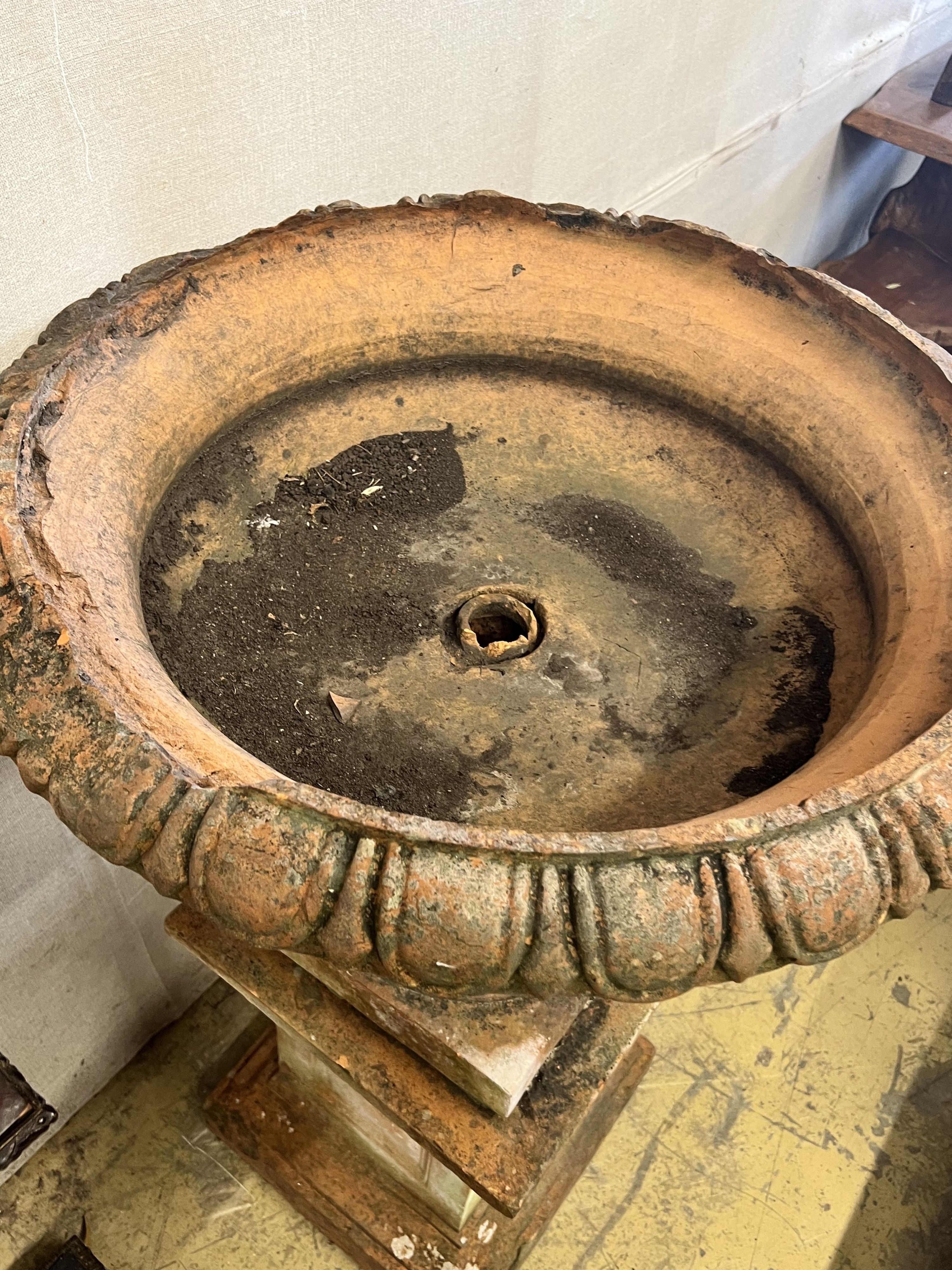 A large terracotta circular campana garden urn on plinth base, diameter 78cm height 118cm